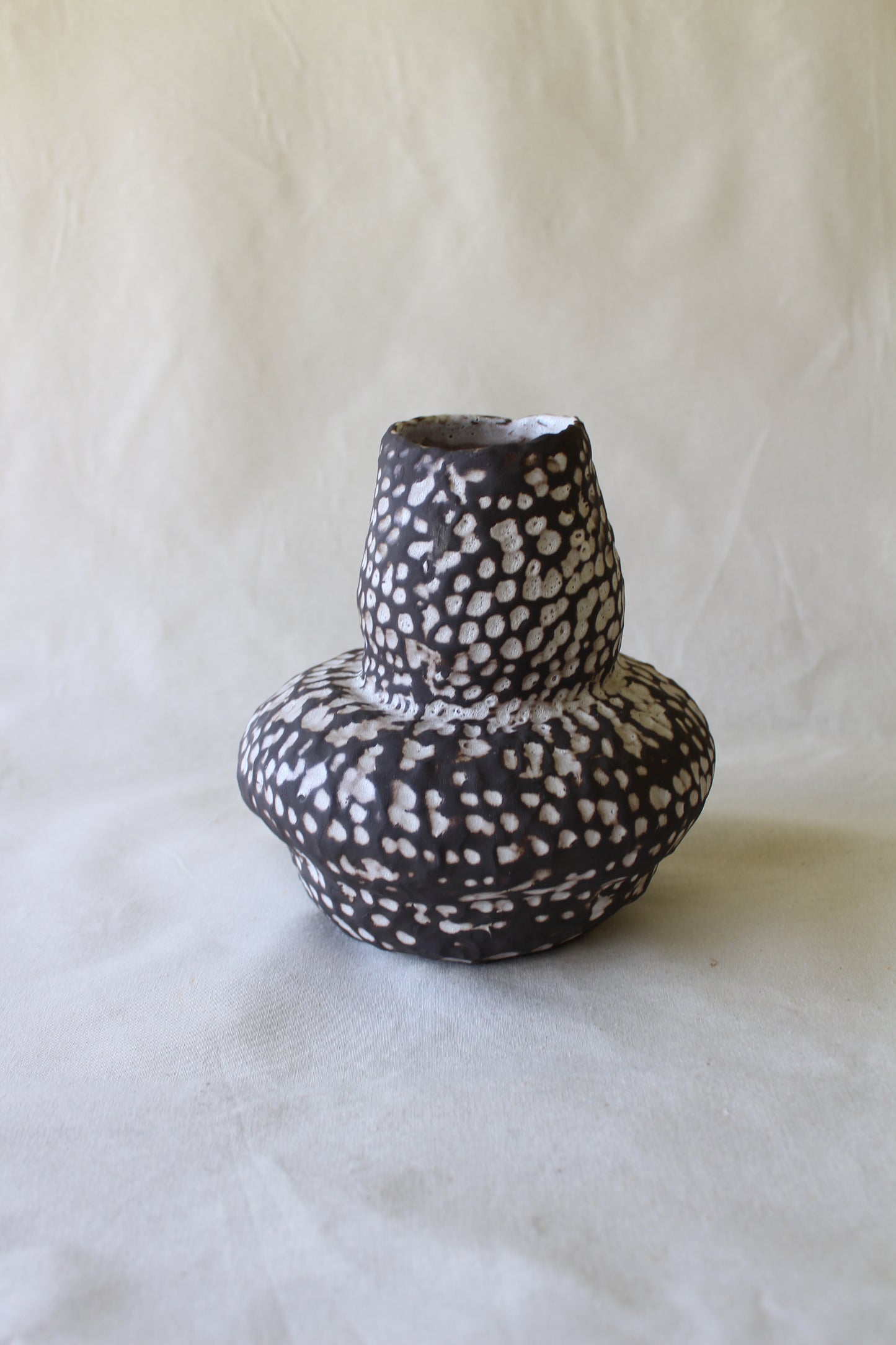 Black stoneware vase with matte white glaze